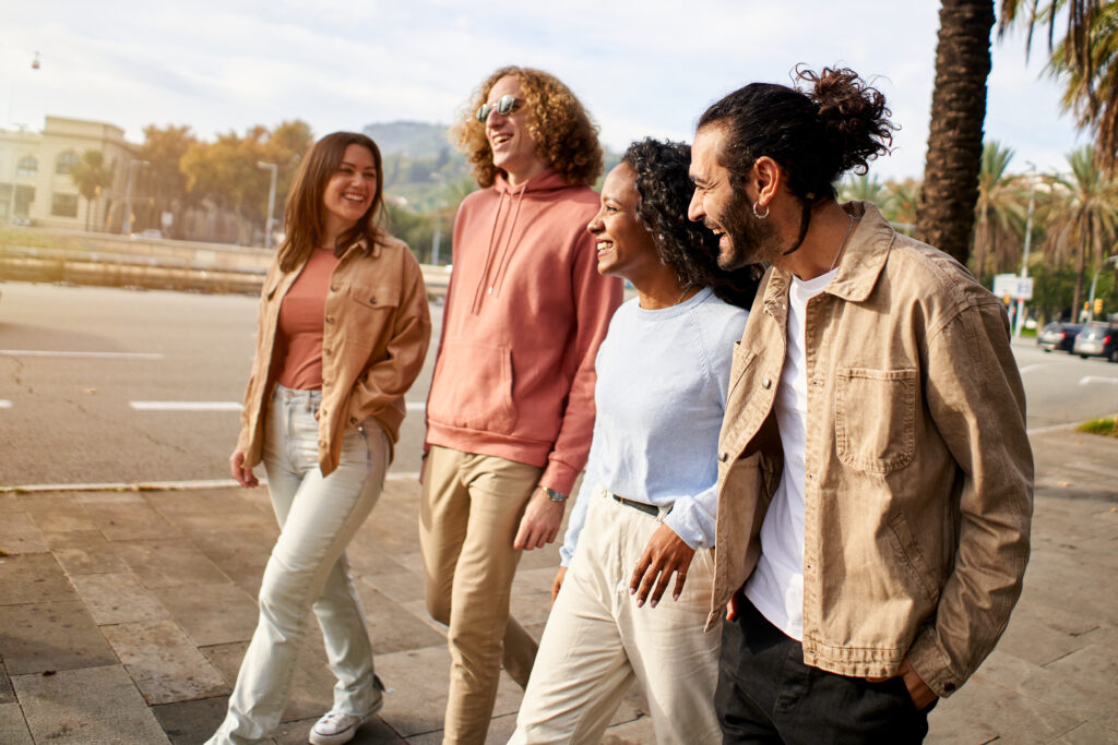 Happy group of friends stroll around the city enjoying the vacation in the city.